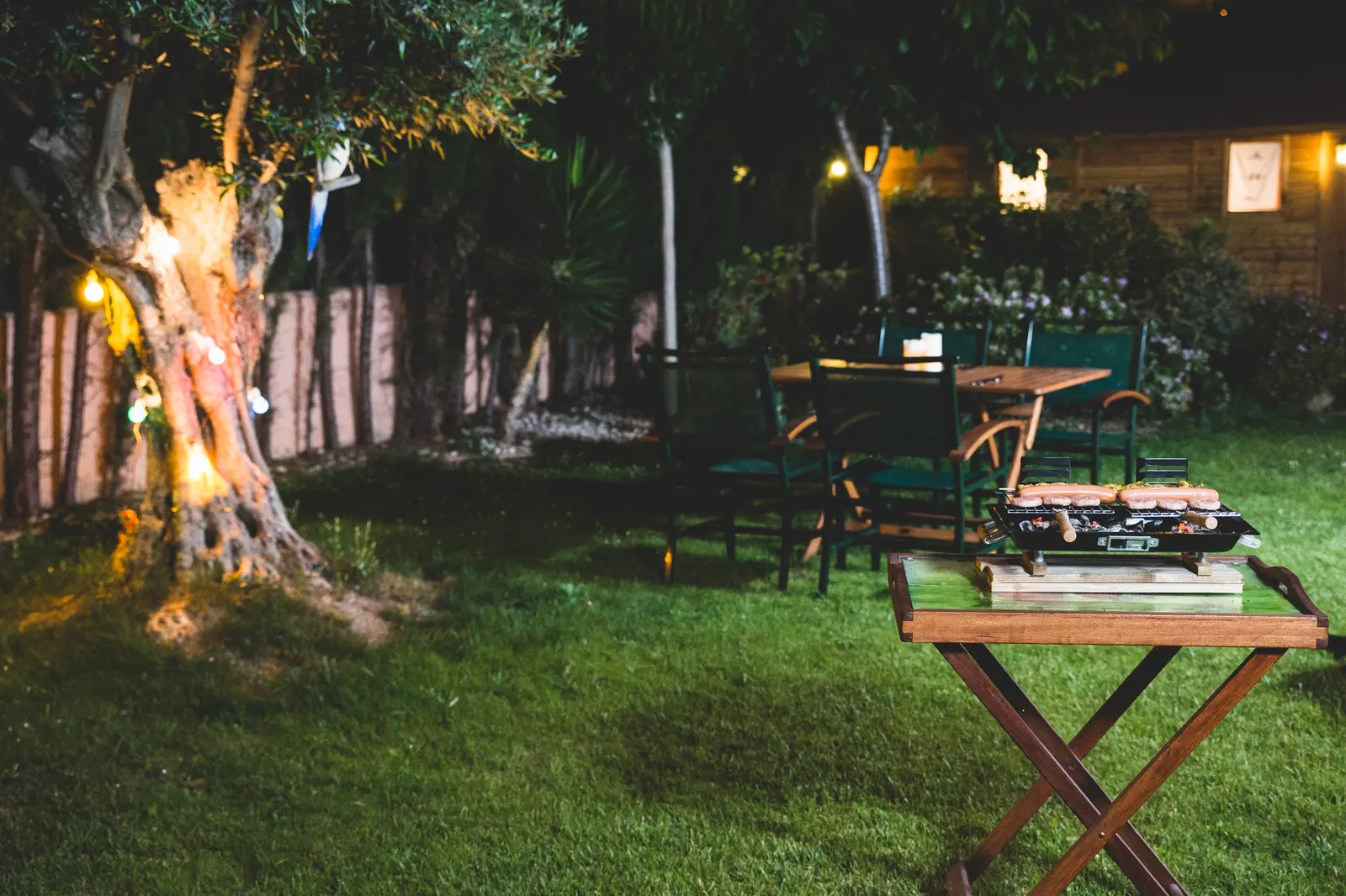 Backyard patio with landscape lighting in Pilot Point, TX